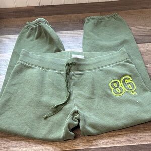Victoria's Secret PINK olive green sweatpants with a neon green '86' graphic